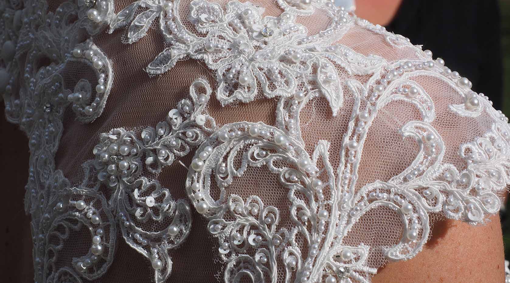 Closeup of lace on a wedding gown.
